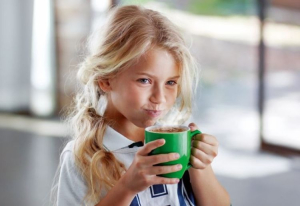 Girl drinking MILO.