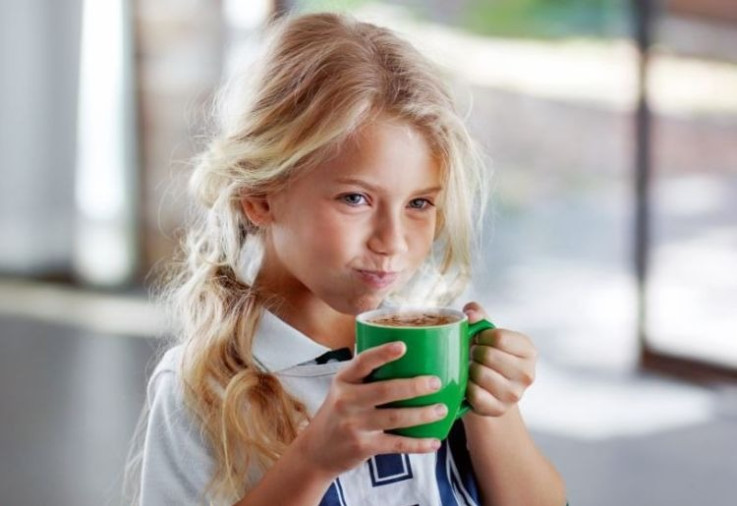 Girl drinking MILO.