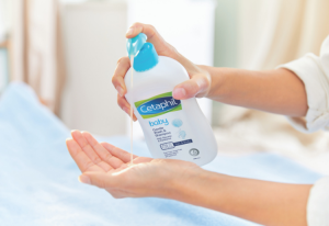 Person pumping Cetaphil into their hand.