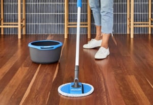 Lady mopping with the Oates Spin & Clean Microfibre Mop Refill.